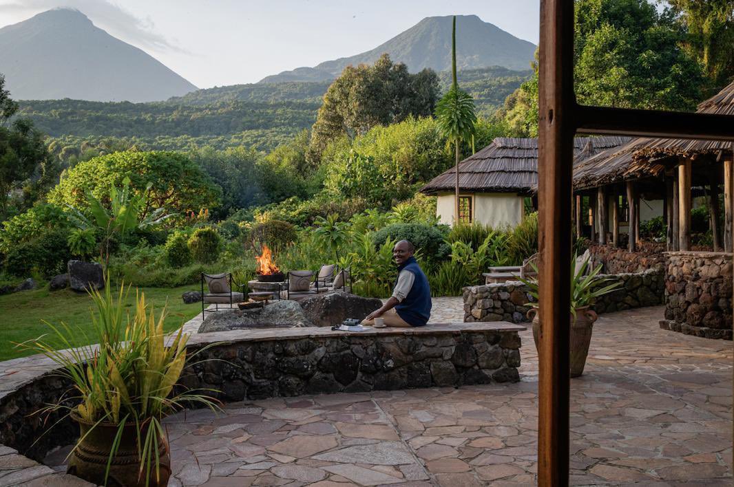 Volcanoes Safaris Guide Robert Rwigenza has found the perfect spot to enjoy the magical views at Mount Gahinga Lodge.

#volcanoessafaris #mountgahingalodge