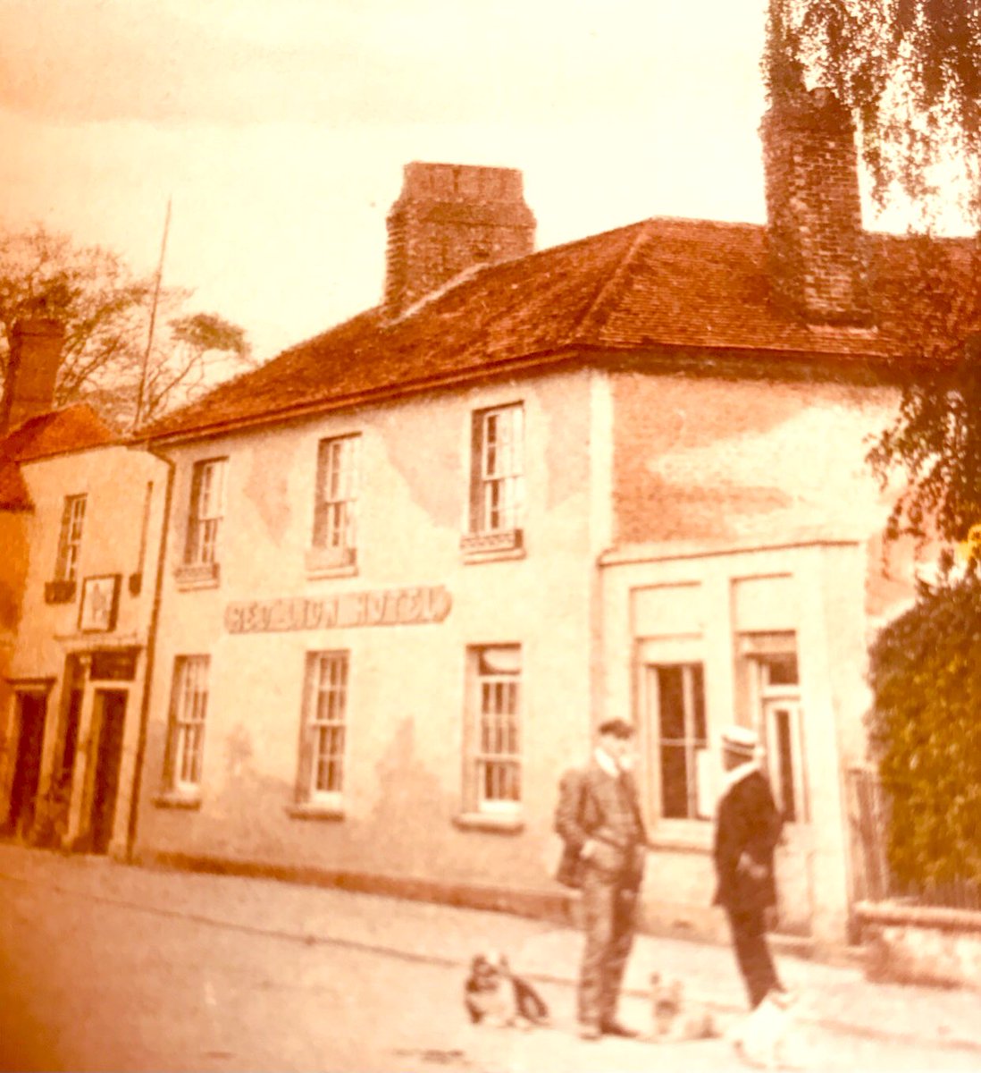 Milford, Godalming, Surrey. The old Red Lion Hotel (now Tesco!). Postcard c 1915, published by F. Frith & Co, Reigate. 
📷: Gentlemen with dogs: one of whom (with white dog) features in nearly all postcards of Milford at this time! 🙂 Believed to be a Mr Nash? From our collection
