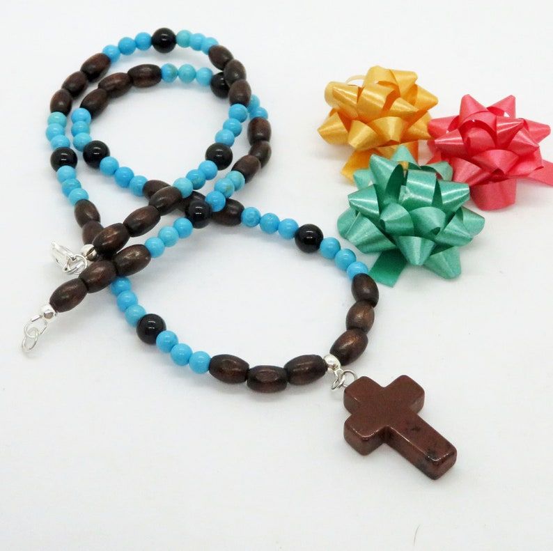 'Mahogany Obsidian Cross with Dark Sugar Maple, Turquoise Magnesite and Black Onyx - a unique necklace for Christian men. Handcrafted by RivendellRocksSedona, this piece is a true statement of faith and style. #ChristianJewelry #HandmadeNecklace' buff.ly/3T1rVlm