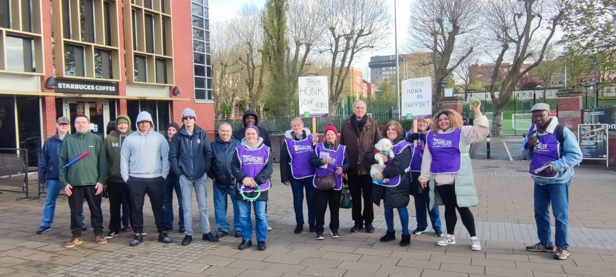 Good morning from our members and supportive doggos on the picket lines! ☀️☕️✊🐩🐾 Support us by donating to our strike fund, link in bio! [img: people looking cheerful on picket line, with dog]