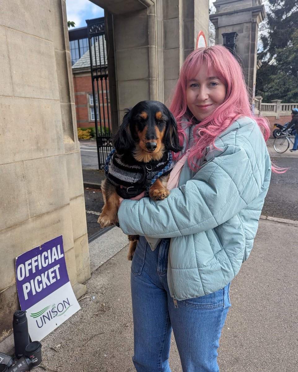 We 💜 our pup supporters 🐾 thanks Franco! 🐶 all doggos will be cuddled at our picket lines 🥰 [img: person with pink hair holding a dachshund in their arms at the picket line]