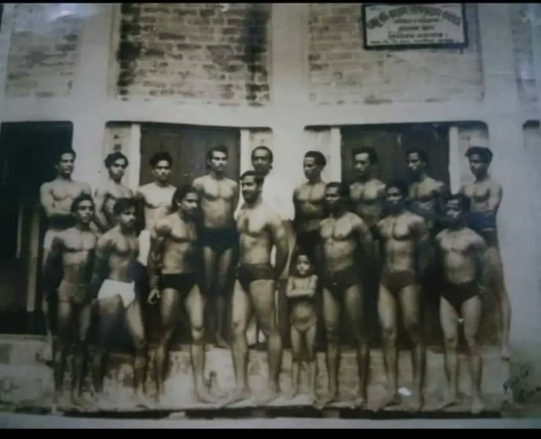 Ironman Nirod Kumar Sarkar with his students in front of his gym. Salkia, Howrah, 1950s or 1960s.