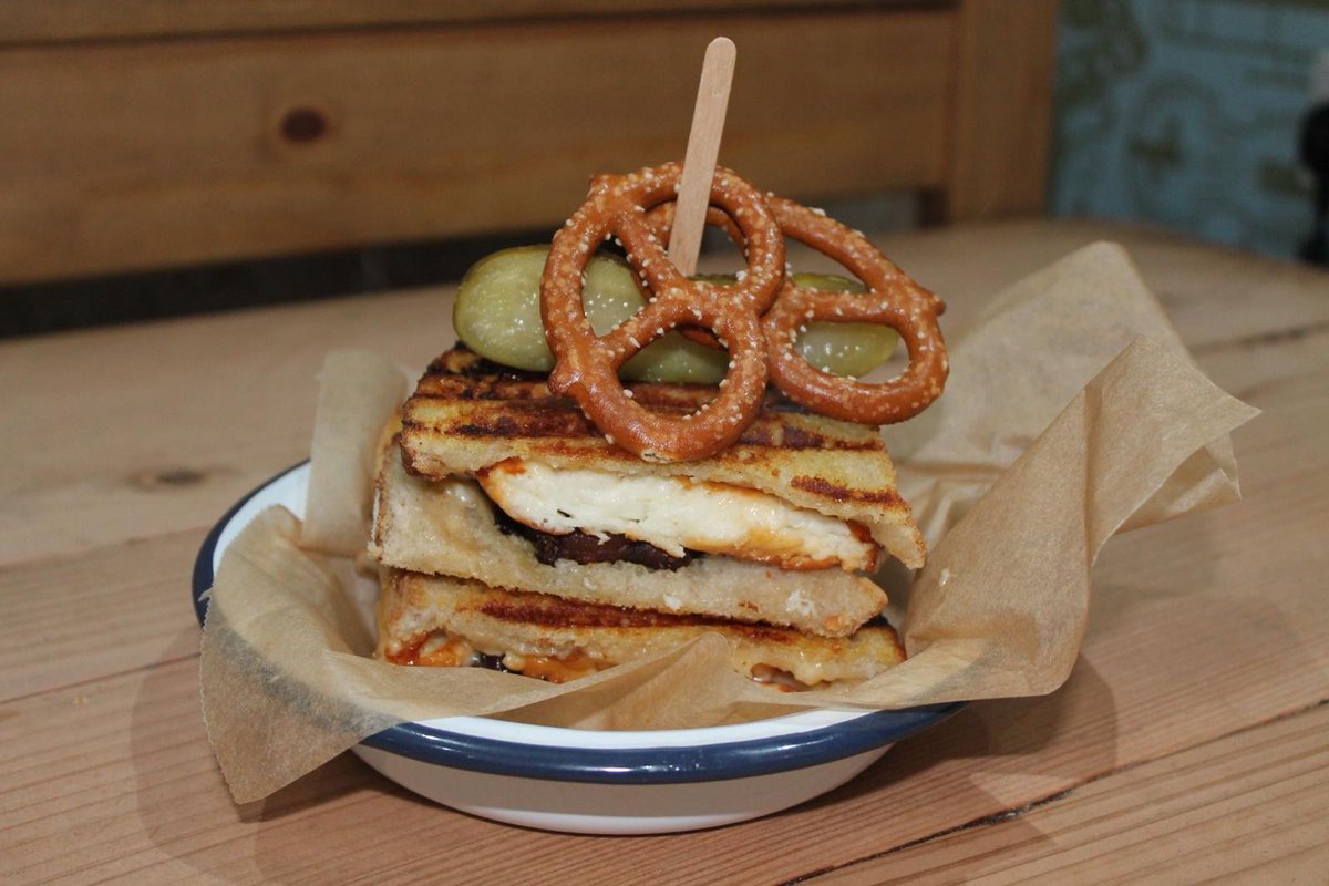 🧀✨ Introducing our #CheesaOfTheWeek: The Bombay Cheesa! 🇮🇳 Halloumi or Vegan Cheddar, Onion Bhaji, Rocket and Mango Chutney Mayo served in crispy Toasted Sourdough and topped with tangy Pickled Gherkin and crunchy Salted Pretzels! 😋 🕓 Open 10 am - 4 pm today