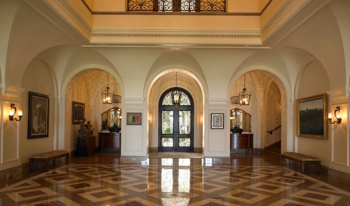 We love the hallway accents in this beautiful home in Coral Gables. Thanks to Coastal Construction, Portuondo Perotti Architects, and Ivette Arango Interiors for their work on this luxurious project. #LuxuryDesign #Woodworking #BespokeInteriors #LuxuryHome #TraditionalDesign