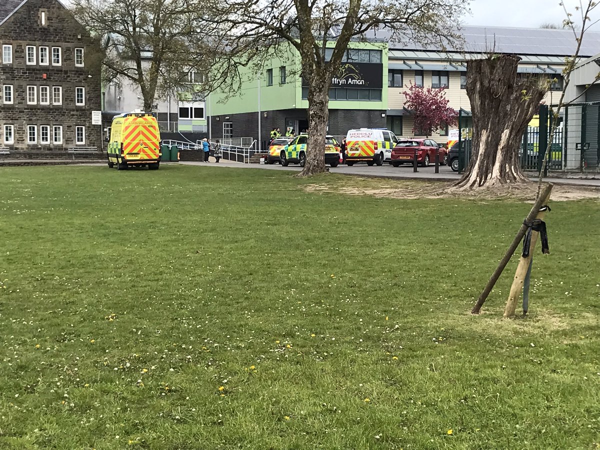 The scene outside Ysgol Dyffryn Aman in Ammanford where three people have been injured. Large police and ambulance presence at the scene. Air ambulance has left. More updates to come.