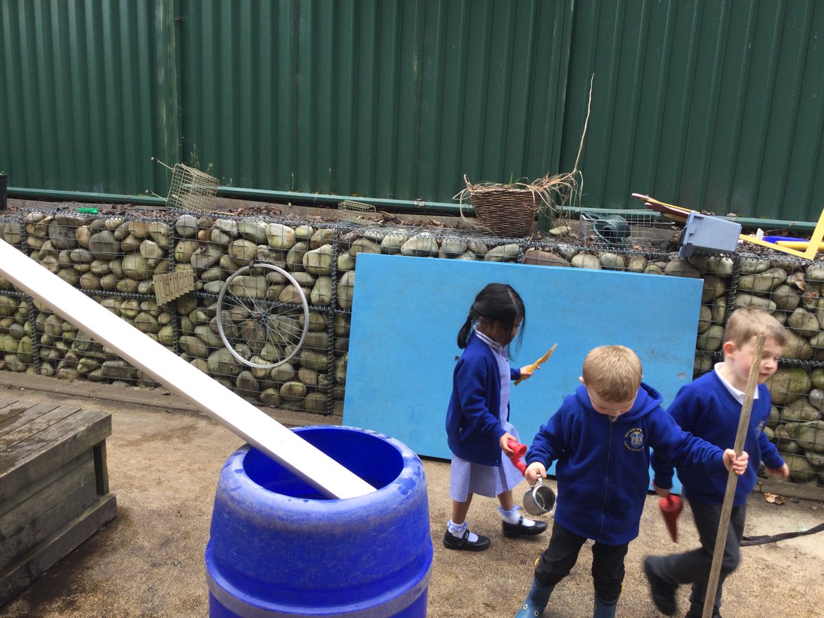 T and S are exploring friction in the outside area. They made a slide to roll the toys into the barrels. They added water to see if it made the animals go faster. #OLOLScience #Understandingtheworld