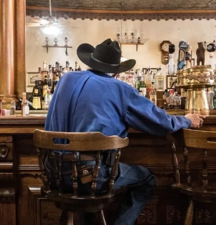 A cowboy, who just moved to Montana from Texas, walks into a bar and orders three mugs of Bud. He sits in the back of the room, drinking a sip out of each one in turn. When he finishes them, he comes back to the bar and orders three more. The bartender approaches and tells the