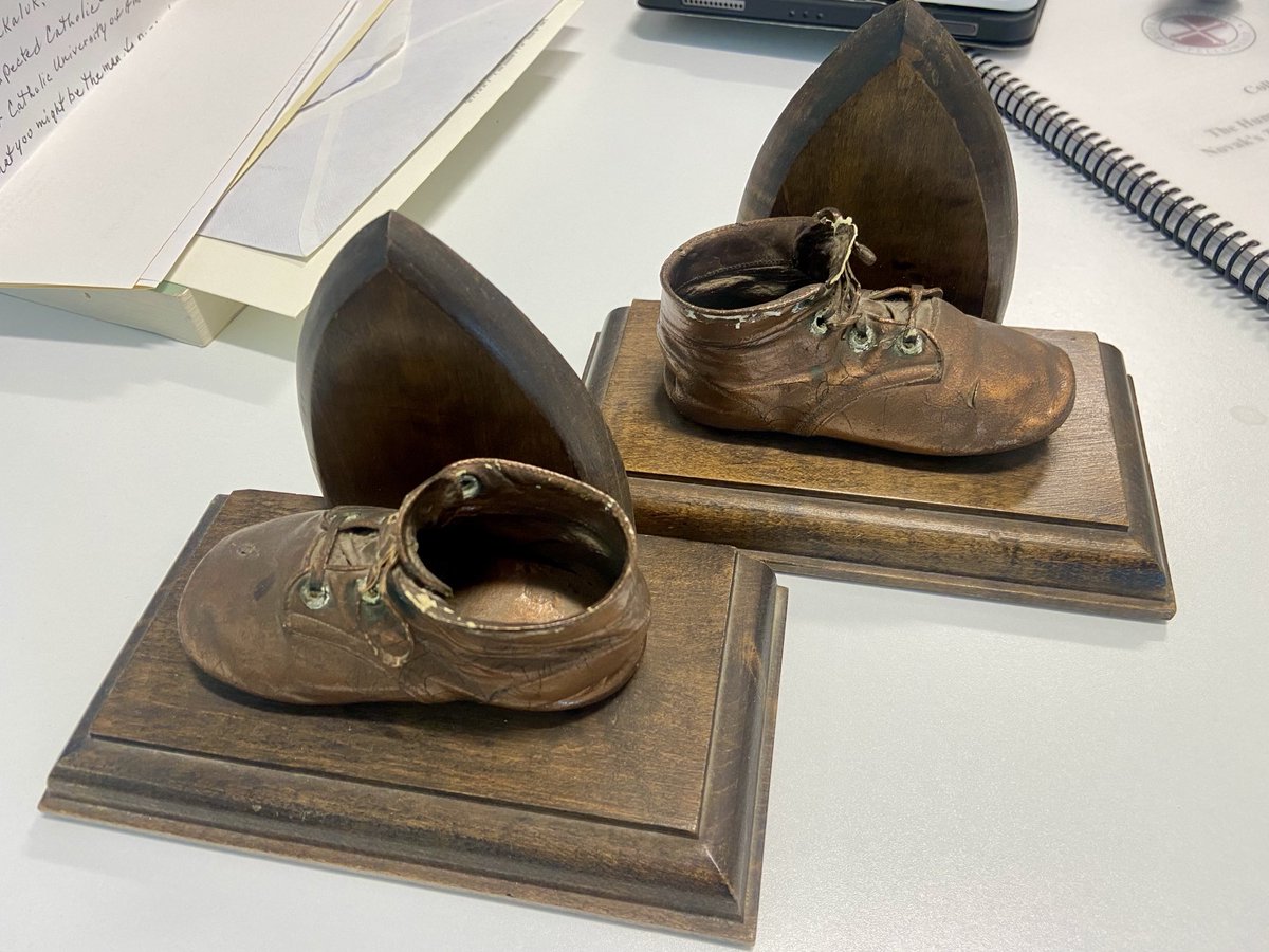 MichaelPakaluk's tweet image. I’m confident no one else has anything like this in their office.  These, the bronzed baby shoes of Michael Novak. A gift of his family.  
(Maybe they thought, “he can maybe fill these at least” 😂)
