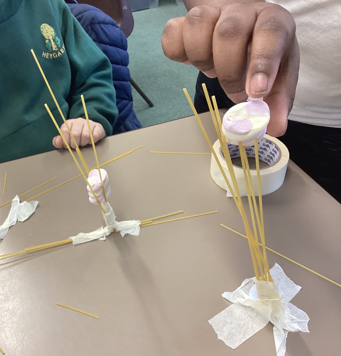 Year 3 construction club. This week we are investigating how to make a tower using spaghetti and tape. It has to be strong enough to hold up a marshmallow. How could we make it stronger or taller? There are spaces left - girls are currently under-represented! @HeygarthPS