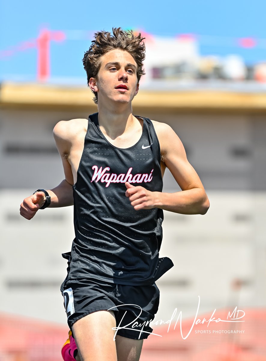 Wapahani Raiders Distance Runner Sophomore Mason Tomboni paces himself with the leader as he rounds turn two in the 1600 meter run during the Muncie Central Relays