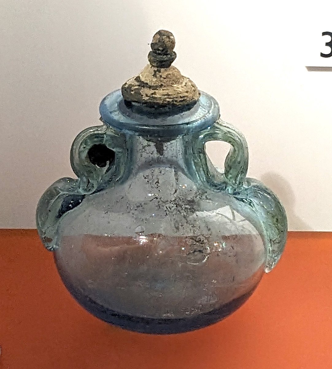 This lovely glass #flask complete with stopper is on display at #Corbridge #Roman Town museum. The handles have been made in the shape of stylised / abstract dolphins.
