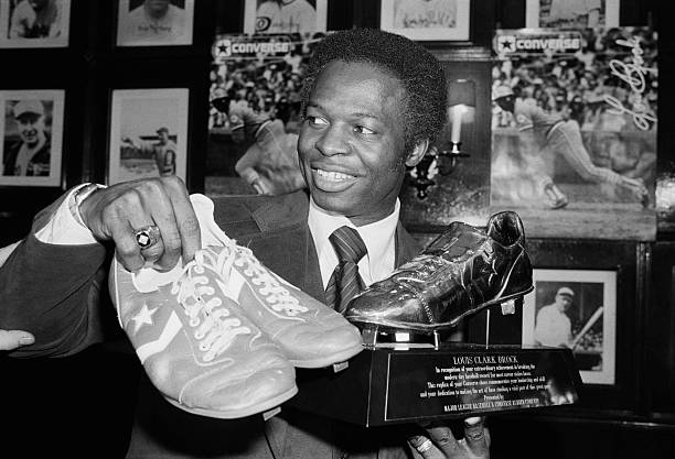 Jimfrombaseball's tweet photo. "When it came to stealing bases, Lou Brock was the black Red Baron. He stole 917 bases in his 18-year HOF career & for him sneaking from first base to second base was more than just a 90-foot sprint."
Scott Ostler
Lou Brock, stops enroute to spring training to present his record-breaking baseball shoes, to Baseball HOF, `78