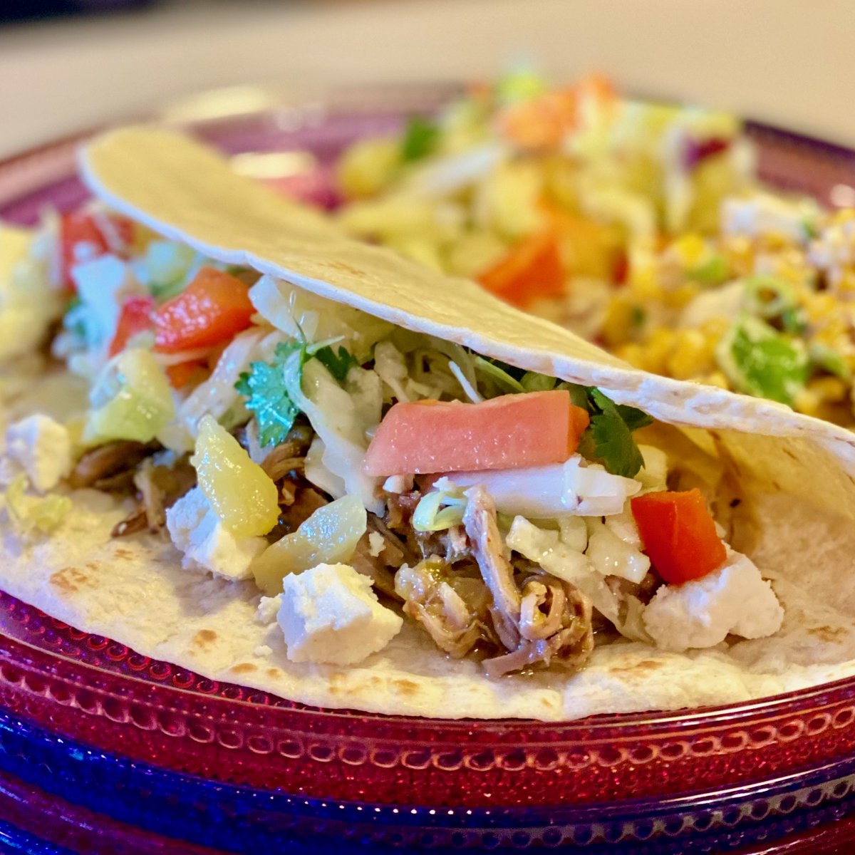 Pork tacos with pineapple-papaya slaw and Mexican crumbling cheese with a side of street corn.