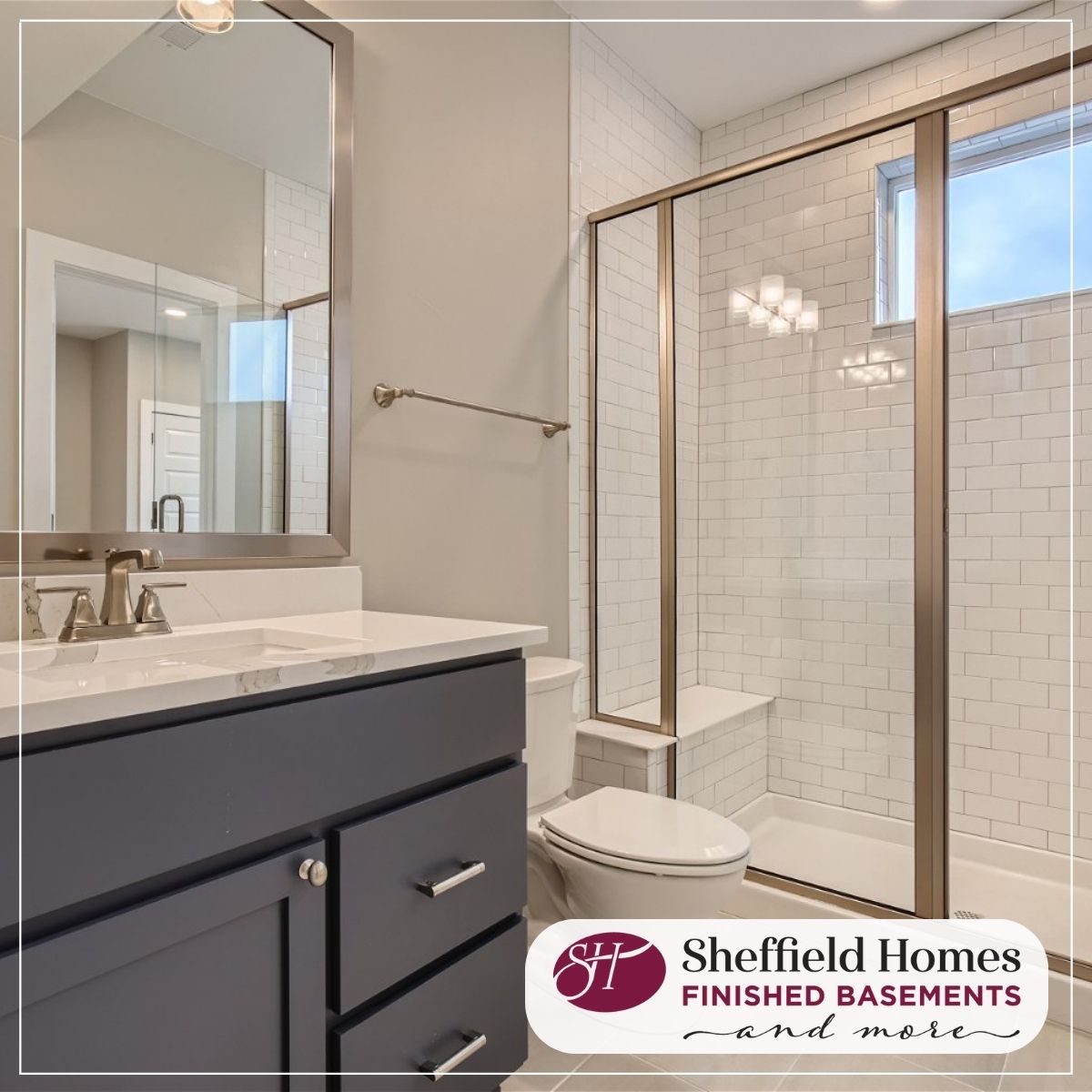 finbasements's tweet photo. A beautiful bathroom isn't out of budget when you make smart selections like the ones shown here. Dramatic navy cabinets set against the soft gleam of champagne bronze fixtures and a backdrop of herringbone-set subway tile make this basement bathroom anything but ordinary! https://t.co/Cfm1TJQm2X