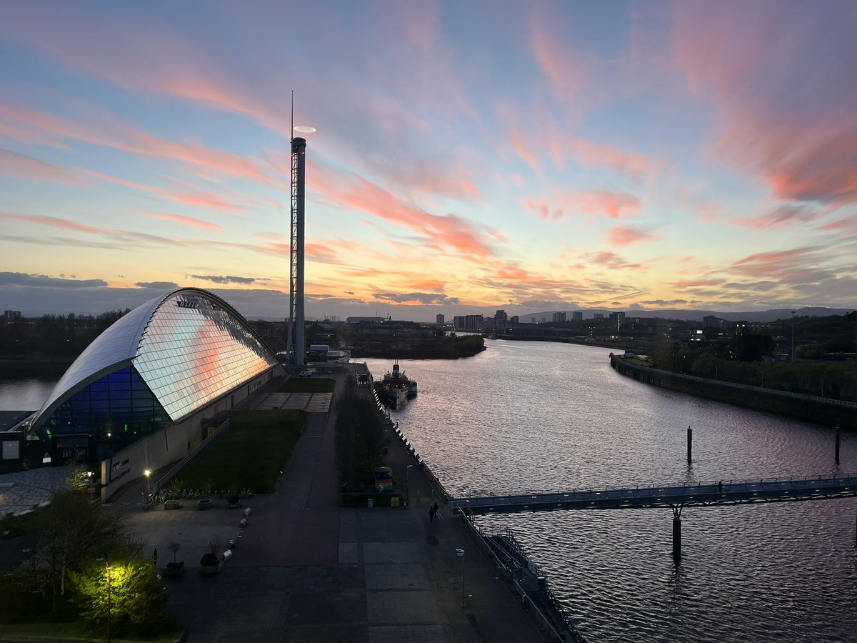 Beautiful pink sky above #Glasgow reflecting on the windows of the Science Centre.