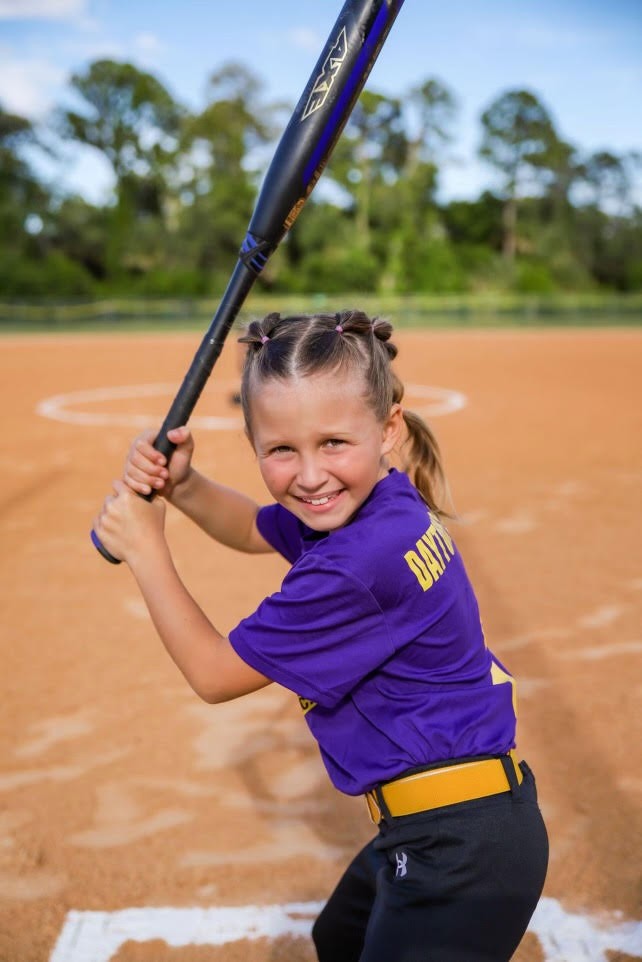 Kali swings a big bat for the tiniest girl on her team! She is also the fastest runner and plays pitcher. She has a real passion for the game and is super fun to watch! #girlssoftball #softball #sports 🥎🇺🇸👍😃❤️