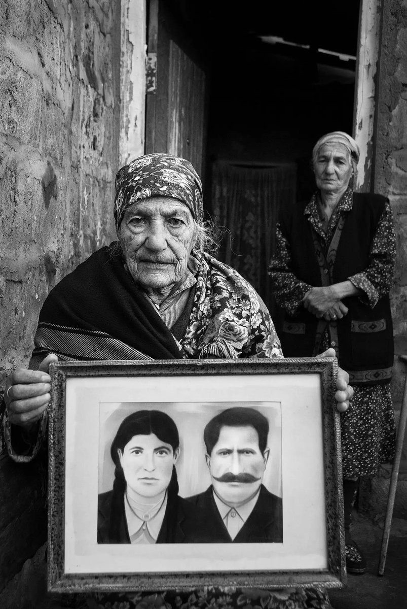 Mariam Avoyan, born in 1901, Bitlis Vilayet, held up a wedding image of herself and her husband, while her daughter stood behind her. 2008. “I remember the massacres. Armenians and Turks lived in peace until then, but afterwards … 5- and 6-year-old children witnessed a whole