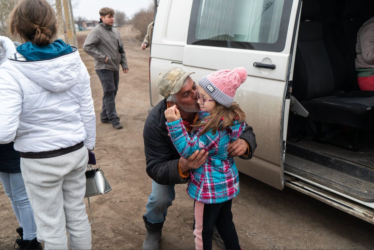 In March 2024, a tender moment captures a grandfather kissing his 8-year-old granddaughter, Polina, as she is evacuating from Andriyivka, a village on the frontline in Kharkiv Oblast, due to the threat of Russian shelling Photo by Oleksandr Stavytskyi / Suspilne Kharkiv