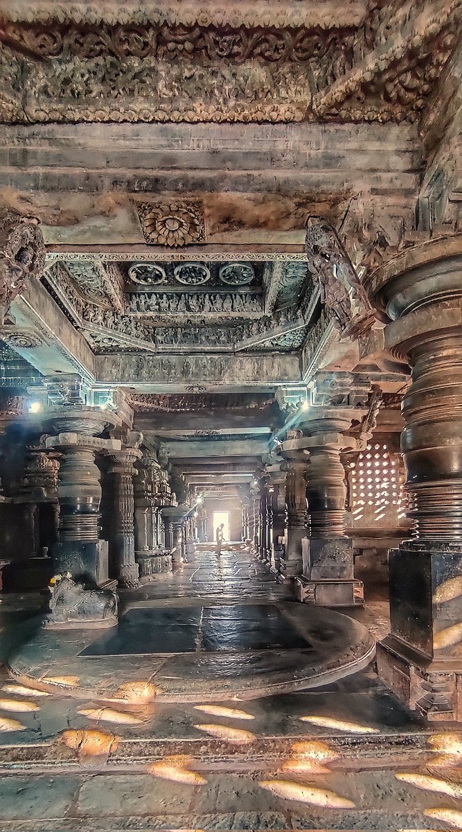 The unique hallway of interconnected twin temples of Hoysaleshwara - Shanthaleshara temple, Halebeedu. Early morning light piercing through the lattice windows can also be seen on the floor
