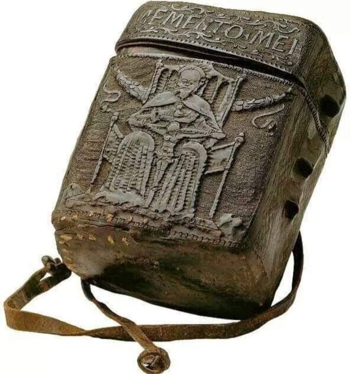 A Black Leather Case; for carrying a book on your belt. Made in Italy in 1465-1485 AD. The design seems to hint that the reading inside is pleasing to God. On the back is an unidentified coats of arms with a crozier and mitre, suggesting that this belonged to a bishop. The Latin…