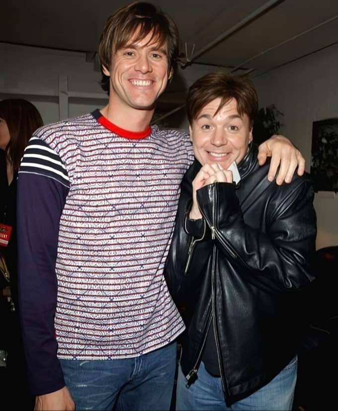 Jim Carrey meet Mike Myers in 1990s or 2000s.

Oh my god! That Grinch and Mr. Cat!