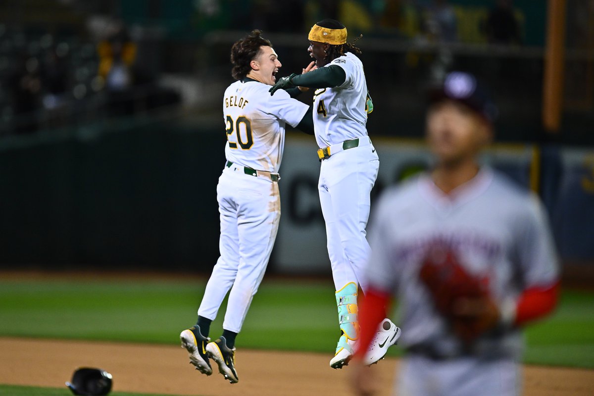 Oakland Athletics' Lawrence Butler (4) celebrates with teammate Zack Gelof (20) after hitting a game winning walk-off single in the 10th inning of their MLB game at the Coliseum in Oakland, Calif., on Friday, April 12, 2024. #rootedinoakland