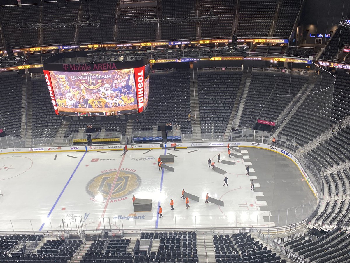 VGK clinch playoffs on Jumbotron above conversion workers transforming arena for Ufc 300 tomorrow