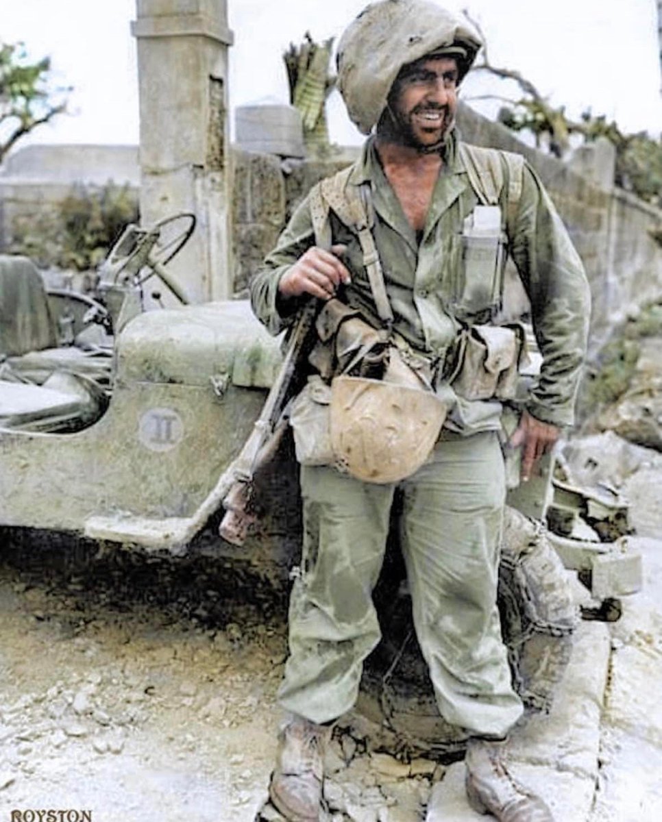 Marine Private First Class Harry 'The Beast' Kizirian of the 6th Marine Division poses for a photograph during the Battle of Okinawa. 🪖