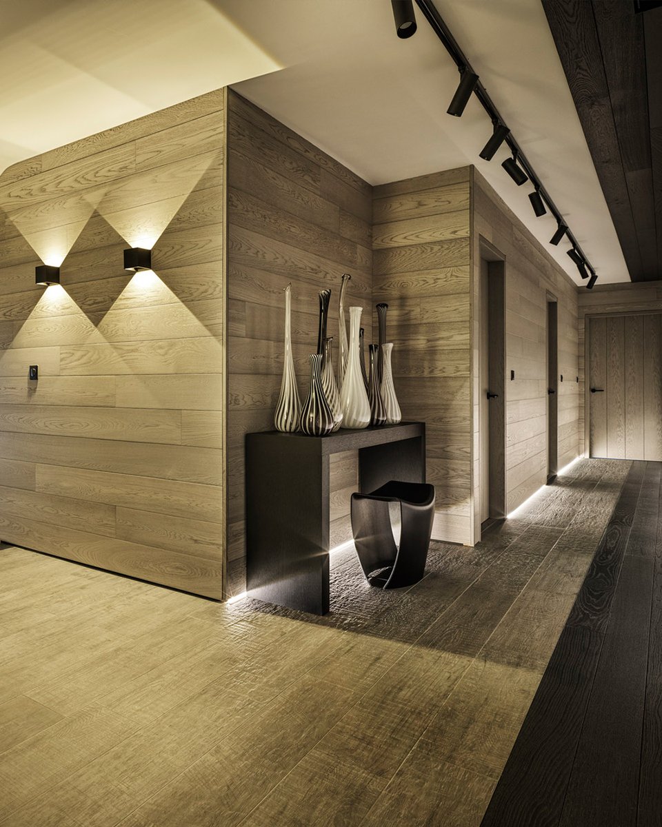 Mountain loving... In this chalet, creating linear lines with darker wood floor and ceiling draws your eye to the end of the hallway, with a juxtaposition of the track lighting, which I love. #kellyhoppen #beforeandafer #interiordesign