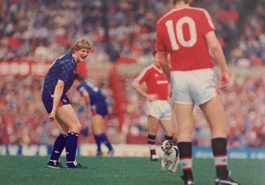 A rare pic ... anyone remembers a dog on the pitch at Old Trafford? ... August 1987 ... MUFC - Chelsea ... Norman Whiteside and Brian McClair look on ... both would score in a 3-1 win ... @Fergie_Years