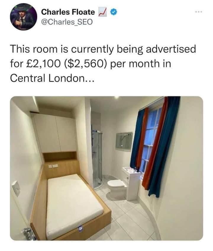 This is unacceptable, but if you want to rent it:
1. Install a sliding screen between the bedroom and bathroom
2. Replace the curtains with a neutral/silver/gold/white pair
3. Dress the bed with pretty bedlinen
4. Go to town with decorative accessories: flowers, candles, pictures