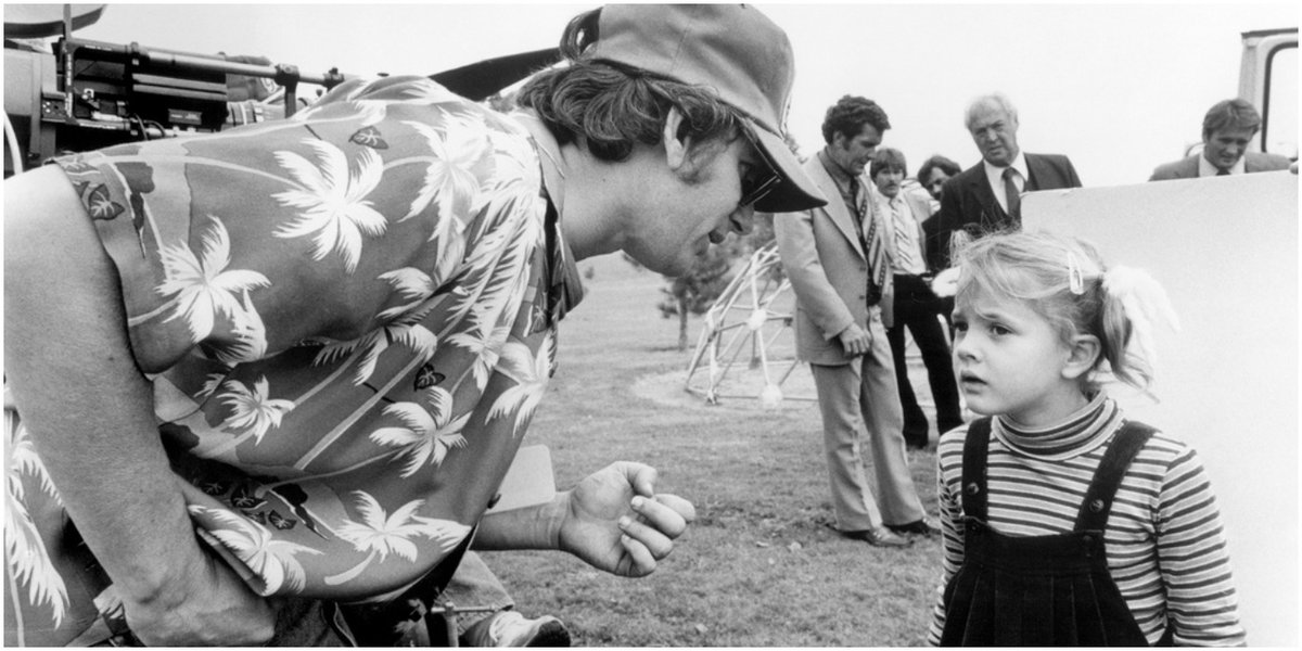 Steven Spielberg and Drew Barrymore on the set of E.T. (1982).