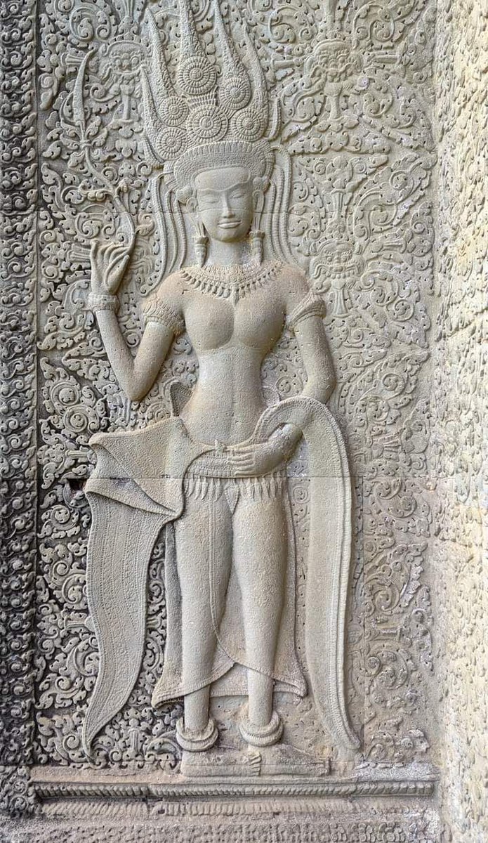 12th century art at Angkor Wat temple. Intricate carvings of sandstone apsara dancers.