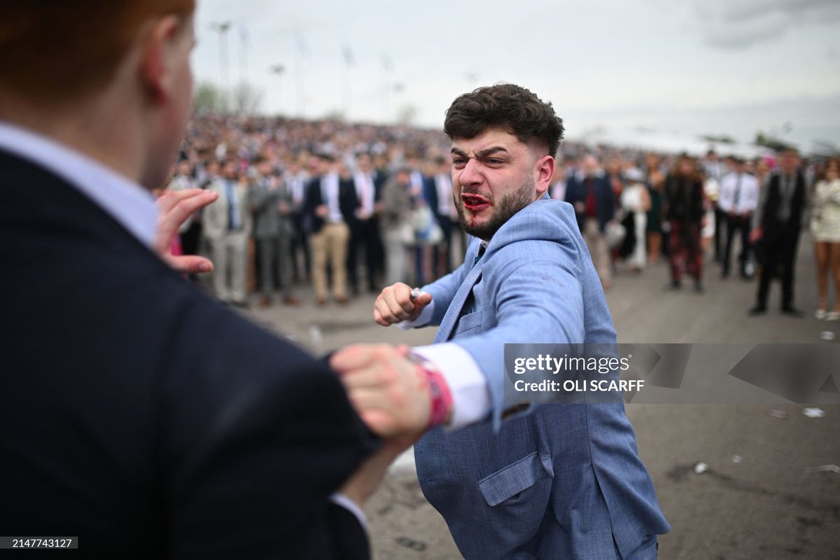 Racegoers fight each other as they scuffle on the second day of the Grand National Festival horse race meeting at Aintree Racecourse in Liverpool, north-west England (2024)

#GrandNational