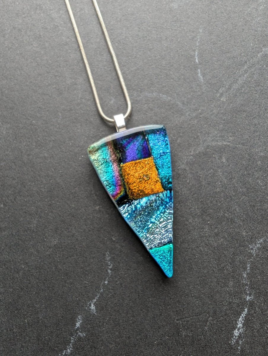 Stunning sparkling colours within this amazing dichroic glass necklace. Lovely handcrafted and handcut dichroic glass pendant. #handmade #etsy #giftideas #shopindie #jewellery buff.ly/3Ucr951