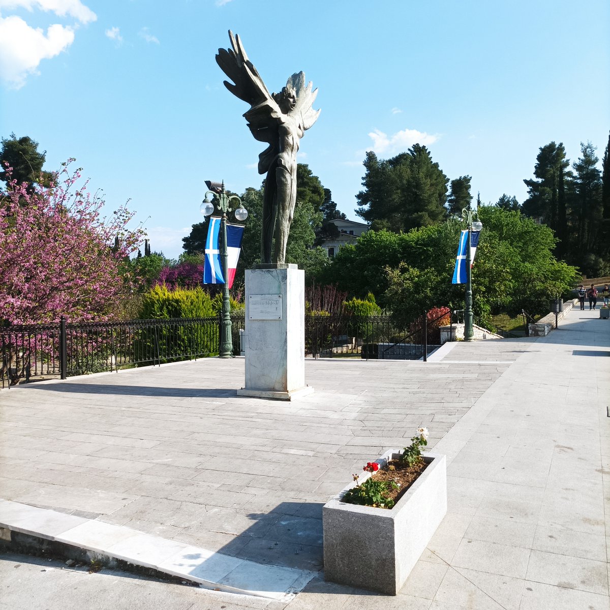 the French tricolor hangs alongside the Greek flag outside the old Town Hall in Ancient Olympia tonight. On Tuesday the Flame for @Paris2024 will be kindled from the rays of the sun not far from this spot in the Temple of Hera.