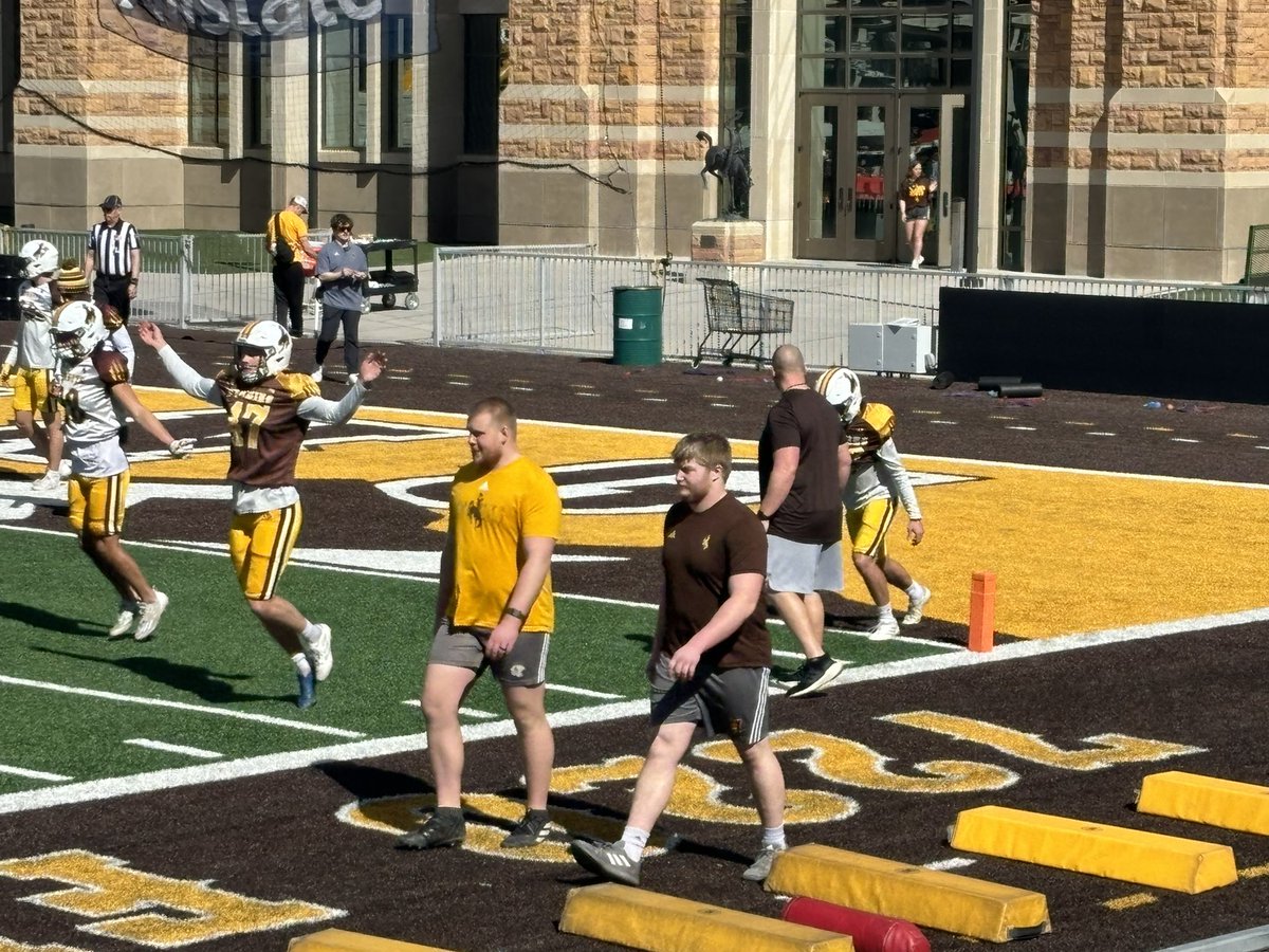 2019 Natrona County grad Jordan Bertagnole walking with teammate and 2023 Natrona grad Cody Crawford