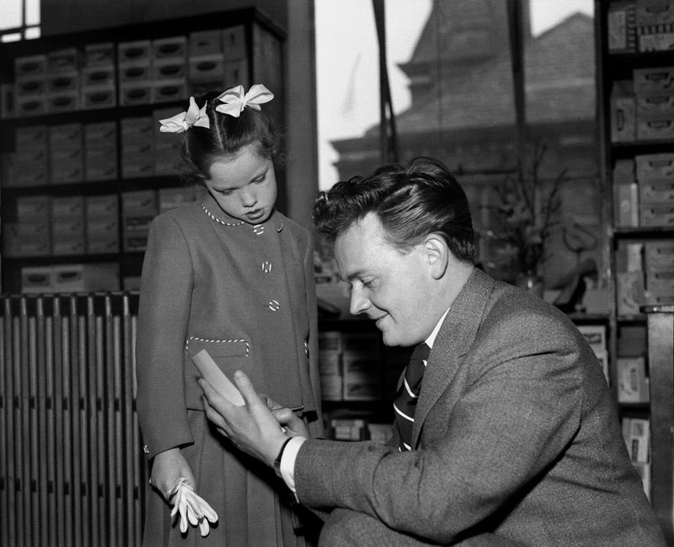 South Shields born Tyne Tees Television news presenter Tom Coyne (1930 - 2015) signs his autograph for a young girl at Hedley Youngs department store at Blyth on 22nd March 1960.