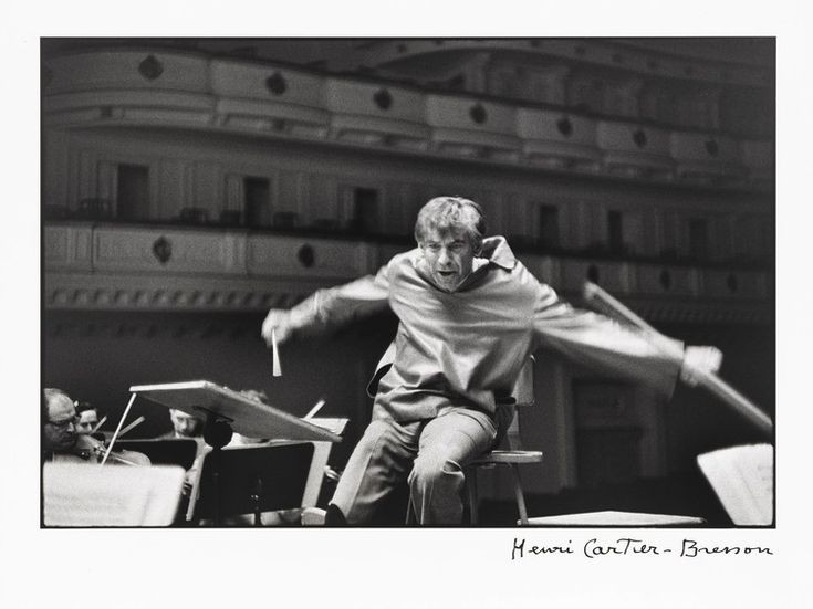 Bernstein looking as though he's participating in down hill skiing rather than conducting.