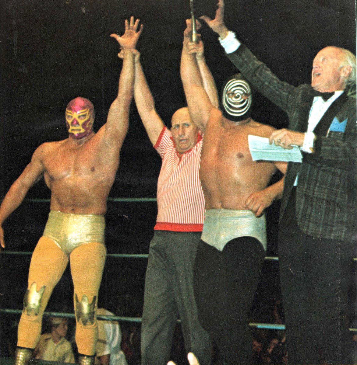 A great photo after a win by the Mascaras Brothers, Mil Mascaras and El Sicodelico, at the @olympicaud . It does not give the date on this photo anywhere, but they did team often, this could be from 1970 after they defeated Great Goliath and Ron Starr. The announcer is Jimmy…