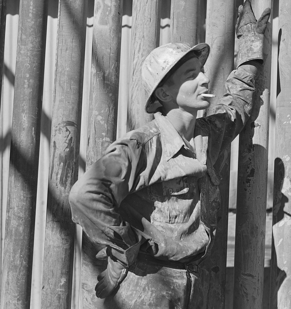 A roughneck takes a smoke break in Andrews County, 1943. Photo by John Vachon.