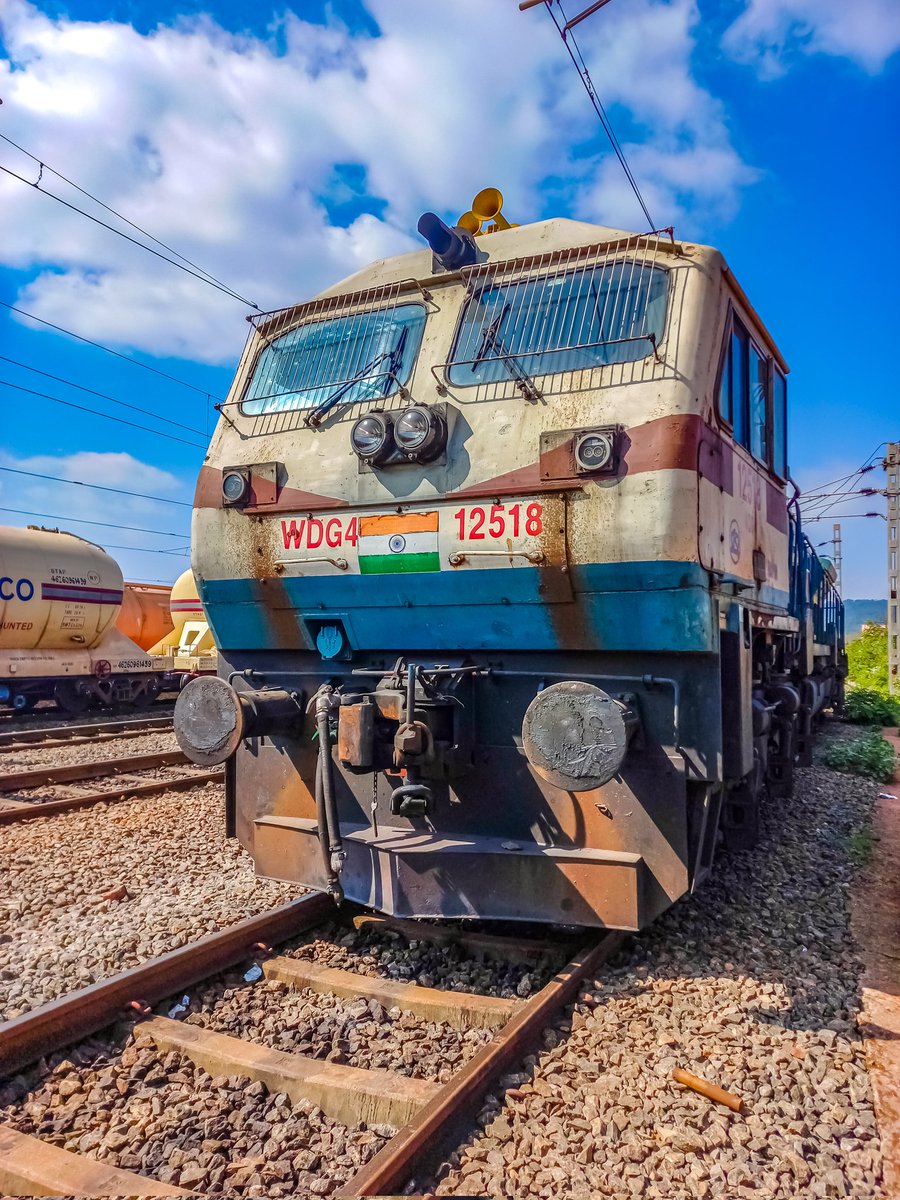 This is a close-up shot of Raipur WDG4 12518, christened as 'Airawat.' It appears to be stationed on a railroad track under a clear blue sky. . 📍Damanjodi Railway Station . @AshwiniVaishnaw @OdishaRail @ecor_railfans @RailMinIndia . #India #railways #photooftheday