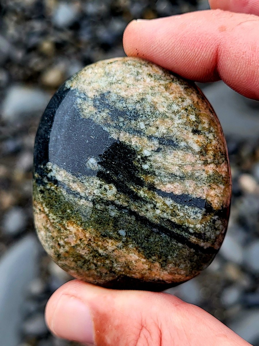 A pretty granitic pebble swirling with colours. County Clare, Ireland.