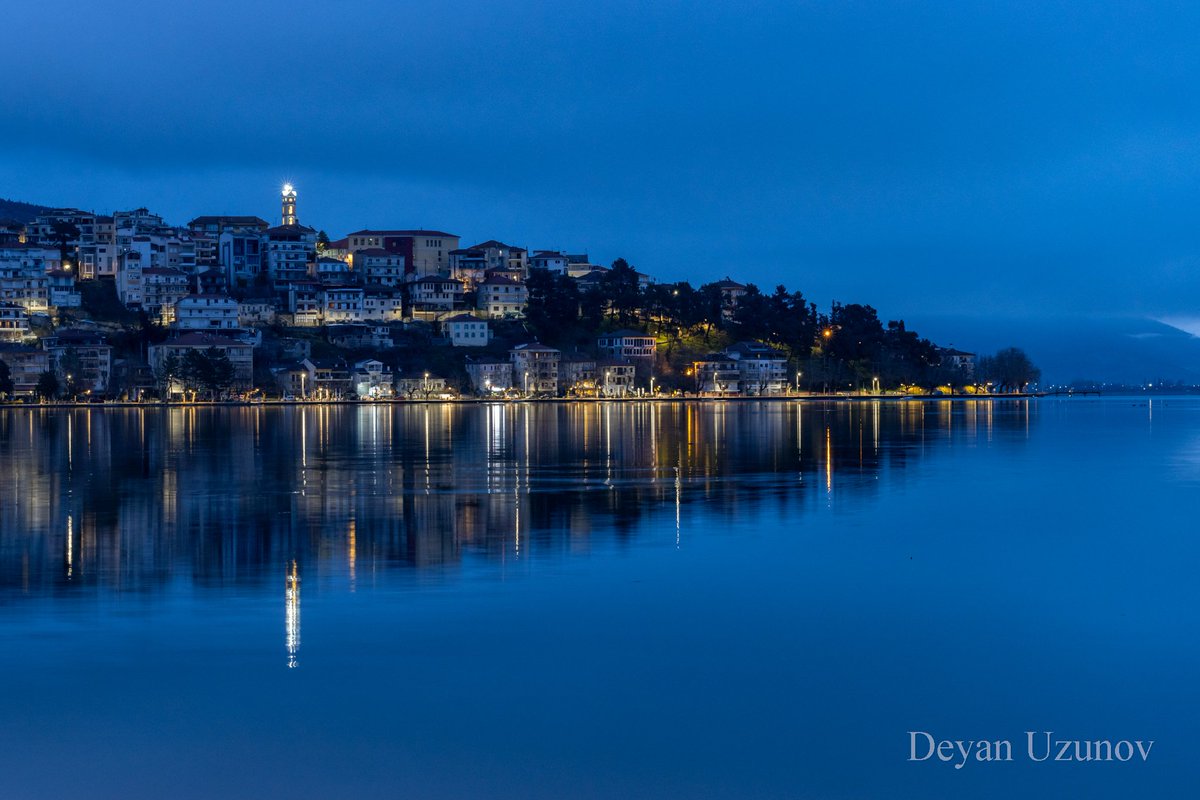 Kastoria at Dawn in Mirror the of Serenity Embracing the tranquil moments before dawn in Kastoria. As the first light of day gently touches the horizon, the city awakens in a breathtaking reflection upon the calm waters of Lake Orestiada.