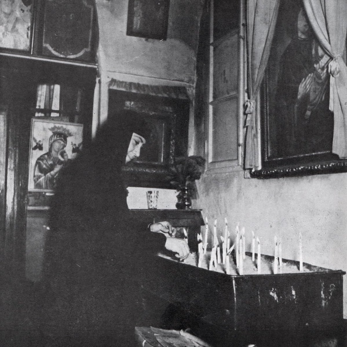 lebanese orthodox nun lighting a candle in the shrine of Sayyidat al-Nouriyyeh (Our Lady of Light) in Beirut