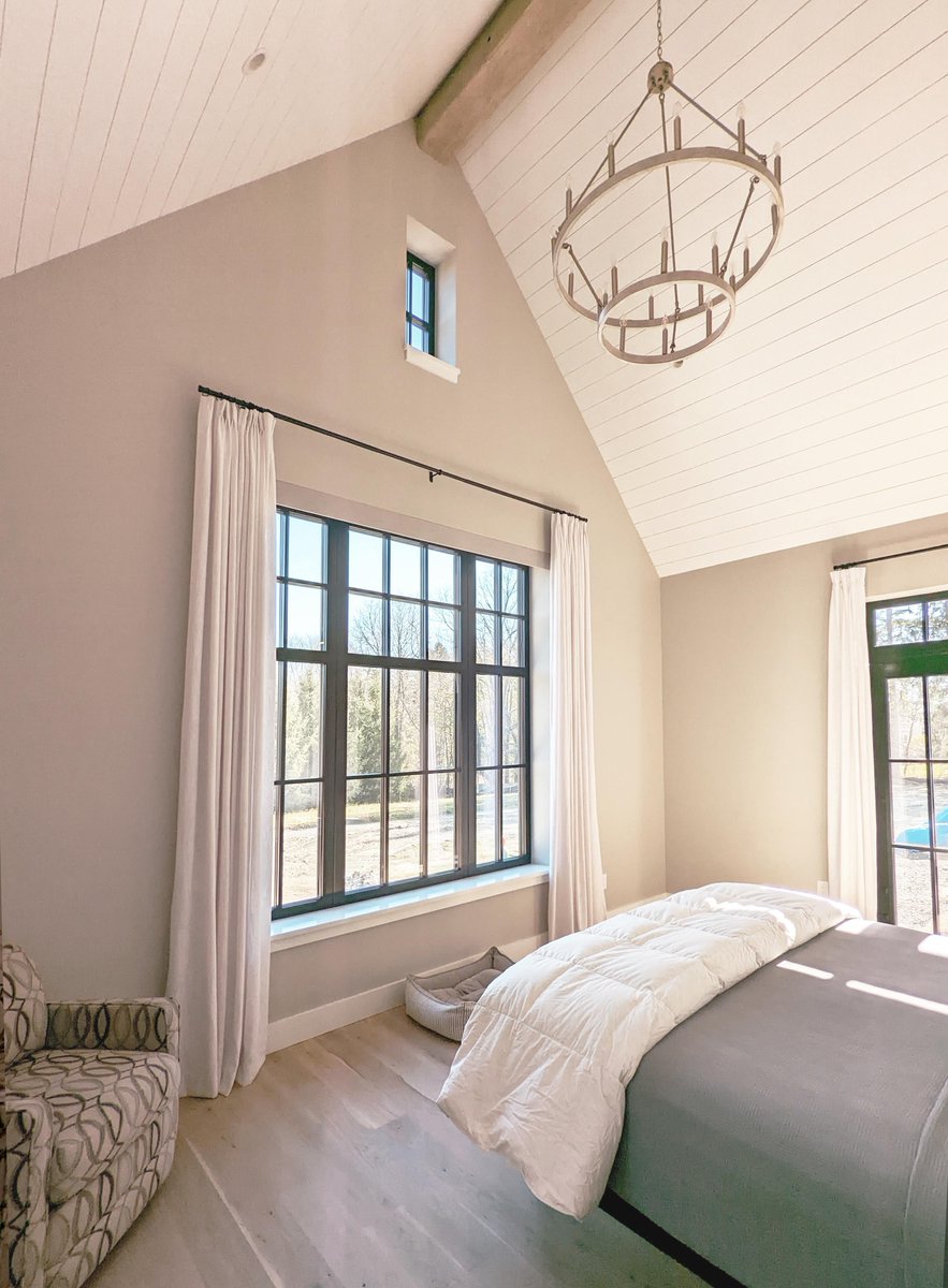 Inspired by a modern farmhouse transitional style, this 4600 sq ft home offers a double-height primary bedroom taking advantage of large east-facing European windows.  bit.ly/3xjzcQg
 #SustainableHome #passivehouse #netzero #architecture #greenarchitect