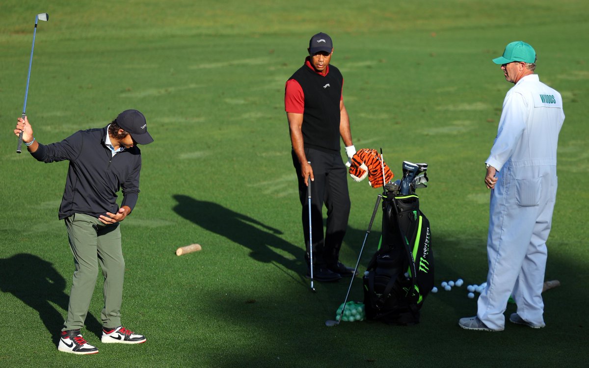 Tiger Woods in Sunday red with Charlie giving him swing pointers. 🤌🔴 #TheMasters