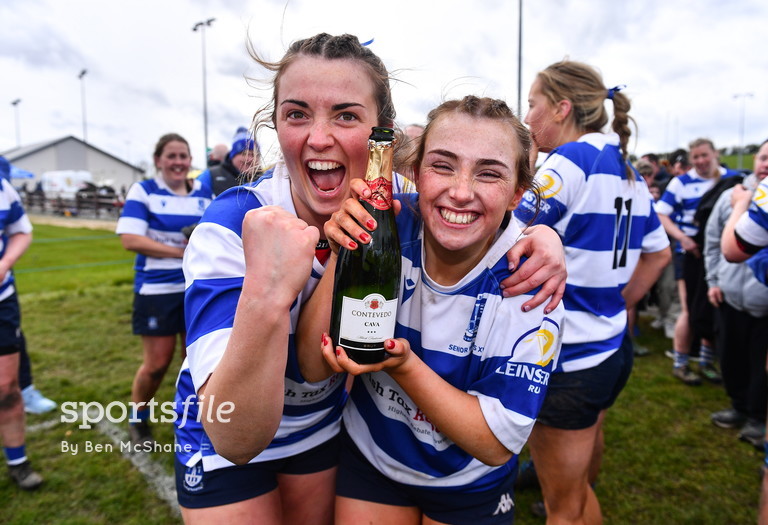 Meabh Collins, left, and Lily Cunningham of Athy celebrate with a bottle of champagne after their side's victory over Ashbourne in the Cusack Plate final during the Bank of Ireland Leinster Rugby Women Finals Day at Balbriggan RFC. 📸 @sportsfileben sportsfile.com/more-images/11…