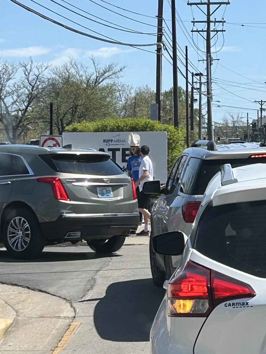 The huge parking lot outside Rupp Arena is absolutely slammed. And there is, of course, a fan in a pope hat.