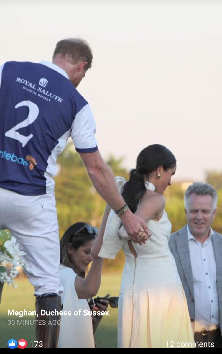 She's literally pulling him off the stage 🤣 while being helped by 2 people . Guess those 10 inch heels aren't good on grass